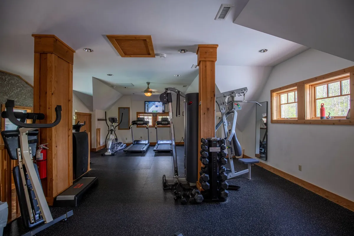 A well-appointed fitness center featuring treadmills, free weights, and other exercise equipment. The space is filled with natural light, creating an energizing environment ideal for workouts, group classes, or personal training sessions.